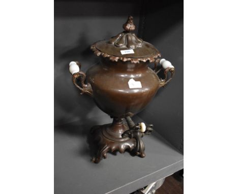 A Victorian samovar tea urn having a copper body with ceramic handles and shell form decoration.