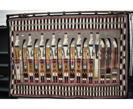 A 20th century Native American Navajo First Nations tapestry of three visitors meeting a fourteen villagers. 200cm wide by 13