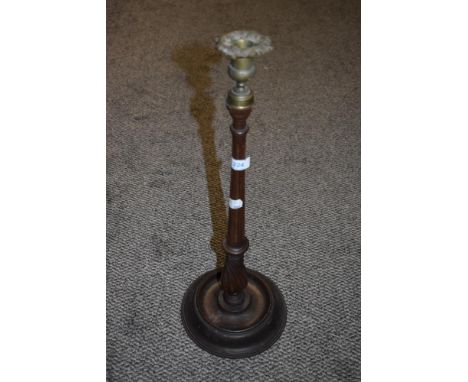 An early 20th century turned mahogany candlestick