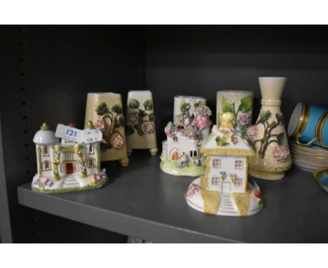 Two Coalport ceramic model houses with four spill vases.