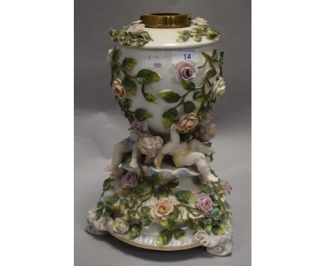 A Victorian German Sitzendorf type porcelain oil lamp base with cherub supports and floral decoration in very fine condition.