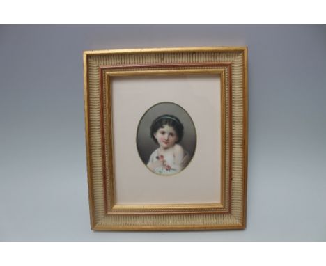 A 19TH CENTURY CONTINENTAL HAND PAINTED OVAL PORCELAIN PLAQUE, depicting a half length portrait of a young girl holding a spr