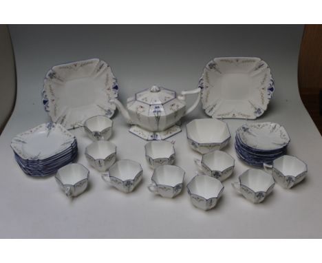 A SHELLEY BLUE IRIS TEA SERVICE, consisting  of angular teapot and teapot stand, two cake plates, sugar bowl, twelve side pla