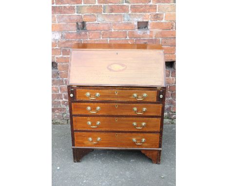 AN EDWARDIAN MAHOGANY INLAID BUREAU, the fall front inlaid with a central conch shell design in satinwood, four graduating dr