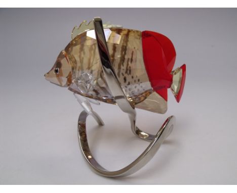 A SWAROVSKI CRYSTAL BUTTERFLY FISH, in light Siam, raised on a stylised chrome metal base, stamped with Swarovski logo, H 10 