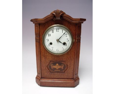 A HAMBURG AMERICAN CLOCK CO. MANTEL CLOCK, eight day movement stamped with crossed arrows, enamelled face with numerals, the 