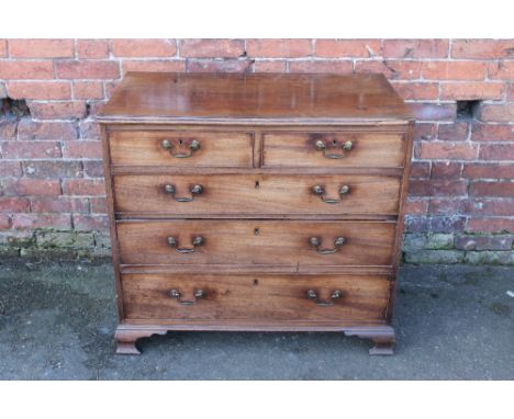 A 19TH CENTURY MAHOGANY CHEST OF DRAWERS, with two short above three longer graduated drawers, raised on shaped bracket feet,