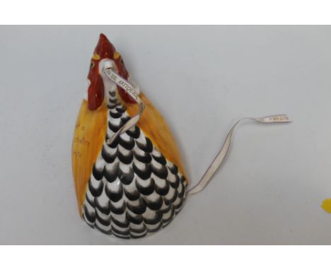 A ROYAL WORCESTER STRING BOX COCKEREL, naturalistically modelled and enamelled in red, the yellow feather breast inscribed 'Q