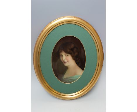 A LATE 19TH CENTURY ENGLISH OVAL PORCELAIN PORTRAIT PLAQUE, signed 'Leslie Johnson', hand painted with a half length portrait