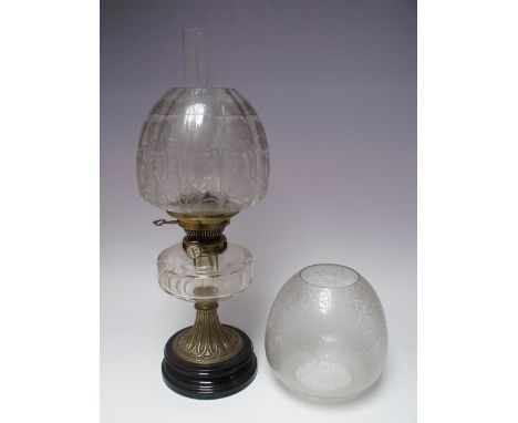 A VICTORIAN OIL LAMP WITH HINKS BURNER, the circular footed base with brass column and glass faceted reservoir, complete with