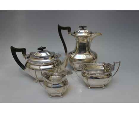 A HEAVY HALLMARKED SILVER FOUR PIECE TEA SERVICE - SHEFFIELD 1918, with ebonised handles, raised upon four bun feet, maker's 