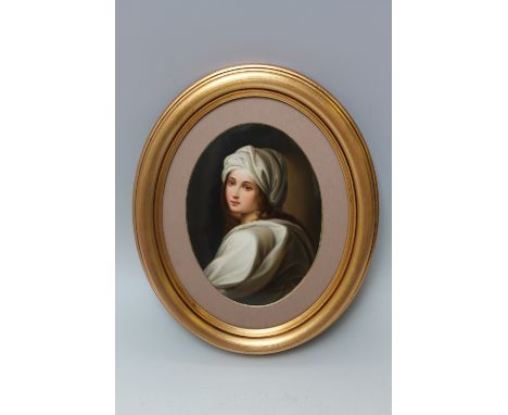 A HAND PAINTED CONTINENTAL OVAL PORCELAIN PLAQUE AFTER GUIDO RENI, depicting a turban clad half length portrait of a young wo