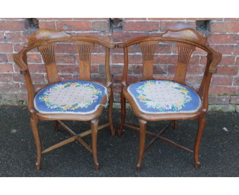 A PAIR OF EDWARDIAN MAHOGANY CORNER CHAIRS, each with inlaid decoration, needlepoint tapestry seats (2)