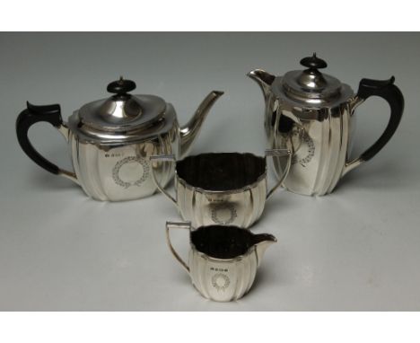 A HALLMARKED SILVER FOUR PIECE TEA & COFFEE SERVICE BY ELKINGTON & CO - BIRMINGHAM 1945, having vacant floral cartouches, app
