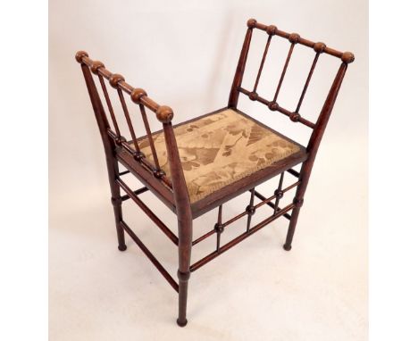 An Arts &amp; Crafts piano stool with bobbin turned side supports in the style of Godwin, 60cm wide 
