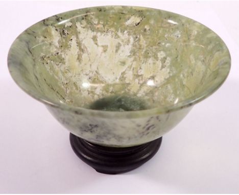 A Chinese jade carved cup on stand, 10cm diameter 