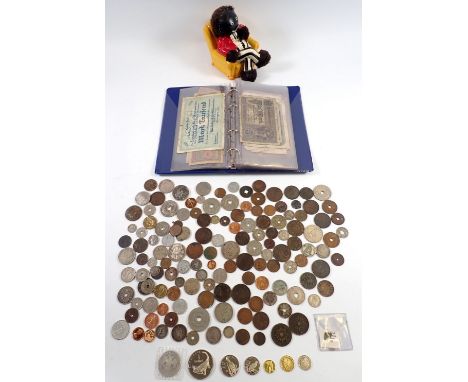 A group of miscellaneous coins and bank notes plus a Robertson Jam style character money box Notice from the the-saleroom.com