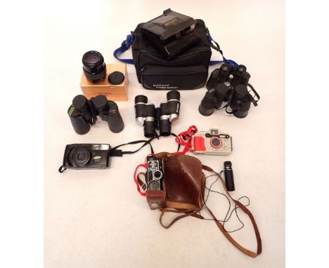A box of various cameras and binoculars including a Canon Sure Shot WP-1, Polaroid Onyx etc. 