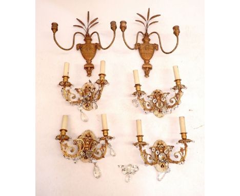A set of four gilt metal mounted light fittings with glass drops and a pair of gilt plaster wall mounted light fittings with 