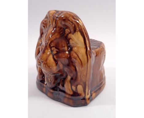 A 19th century brown treacle glazed lion form sash window or furniture rests, 14cm tall 