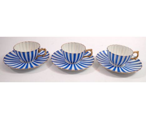 Three blue and white striped tea cups and saucers 