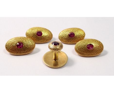 A pair of 18 carat gold cufflinks set rubies, 17.7g and matching tie pin, 4g, on e ruby chipped