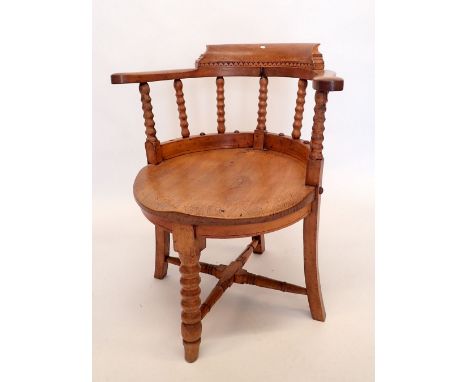 An oak captains chair on bobbin turned supports 