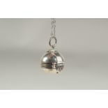 A silver opening ball locket and chain in a box.