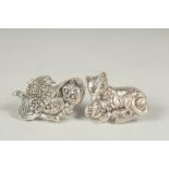 Two silver cat brooches in a box.