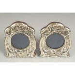 A pair of silver, shaped photograph frames, 110cm x 80cm.