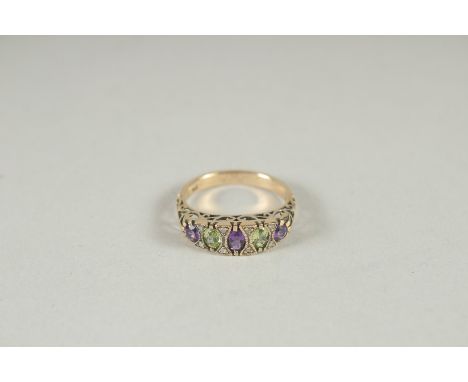 A 9CT GOLD SUFFRAGETTE'S RING, AMETHYST, PERIDOT AND DIAMOND RING.