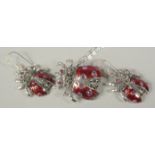 A silver and ruby set ladybird pendant chain and earrings in a box.