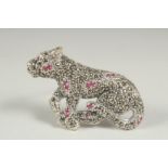 A silver marcasite and ruby panther brooch.