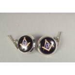 A pair of silver Masonic cufflinks in a box.
