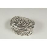 A silver pill box decorated with cherubs, 5cm.