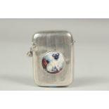 An engine tuned silver vesta case, Birmingham 1914, with a circular enamel of a pug dog.