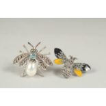 Two silver topaz pearl and emerald bee brooch in a box.