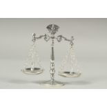 A miniature silver set of scales.