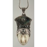 A silver blue topaz abalone face pendant and chain in a box.