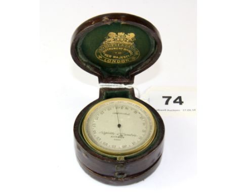 An early leather cased pocket barometer, thermometer and compass by Negretti & Zambra of London, Dia. 5cm.