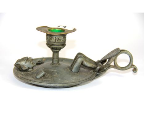 An interesting 19th Century pewter and brass chamber stick of the devil, L. 17cm.