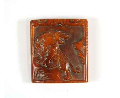 A Tibetan carved yak bone protection amulet of a tiger, 5 x 4.5cm.
