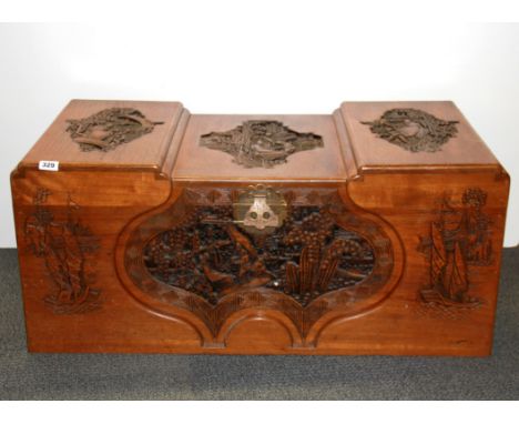 An Oriental carved hardwood trunk, W. 101cm, H. 44cm.