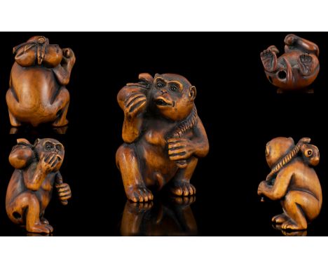 Japanese 19th Century Nice Quality and Signed Carved Boxwood Netsuke, Depicting a Monkey Holding a Large Nut to Right Hand an