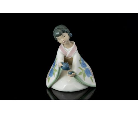 Nao by Lladro Scents of The Orient 1272 Lady Figurine, She Is In An Sitting Position, Holding a Teapot and Cup, Full Stamps t