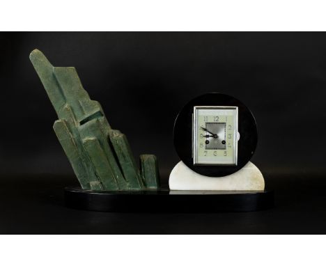 Art Deco Marble And Mixed Metal Mantle Clock Raised on oval black marble base, the clock of typical geometric Art Deco form w