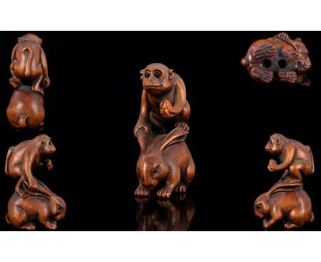 Japanese - 19th Century Nice Quality Signed Carved Boxwood Netsuke. Depicting a Monkey Holding a Nut, Standing on The Back of