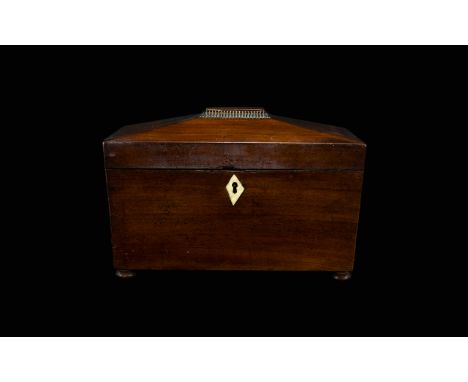 A 19th Century Mahogany Tea Caddy Of Sarcophagus Form With ivory escutcheon raised on bun feet, missing interior. 