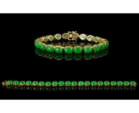 Green Jade Tennis Bracelet, 45cts of oval cut cabochons of Chinese green jade set in 14ct gold vermeil and silver, each caboc