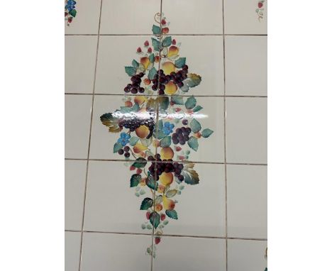 A white pierced ceramic dish with a selection of coloured glass sweet
